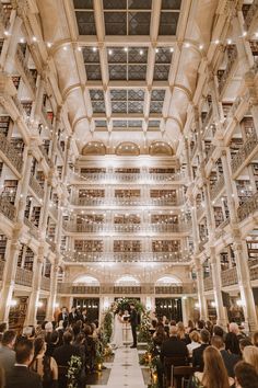 a wedding ceremony in the atrium of a building