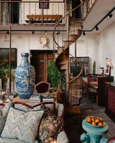 a living room filled with furniture and a spiral staircase