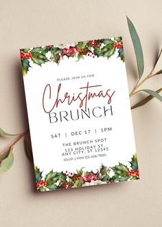 a christmas brunch party card with holly and red berries on the front, surrounded by greenery