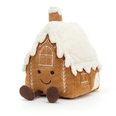 a stuffed gingerbread house sitting on top of a white floor