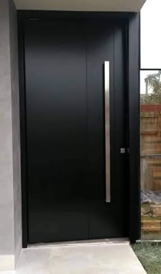 the front door is black and has a metal handle