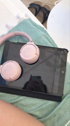 a tablet with headphones sitting on top of it