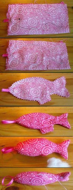 four different types of pink and white fabric on a wooden table with thread spools