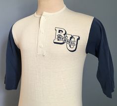 "Vintage 1980s white and navy blue Bucknell Univeristy henley t-shirt. Size: Adult Small (approximate - no tag) 50% cotton, 50% polyester The shirt is very soft and in good vintage condition, with no stains - though big hole on back along collar seam. Approximate measurements with garment laying flat (INCHES): Length (from top of shoulder at collar seam to bottom) : 26\" Sleeve (from top of shoulder seam to cuff edge) : 13.5\" Between Shoulder Seams : 15.5\" Underarm to Underarm :  17.5\"" Vintage College Shirts, College Shirts, College Sweatshirt, College T Shirts, College Hoodies, Vintage Hoodies, Red And White Stripes, Perfect Shirt, Baseball Tshirts