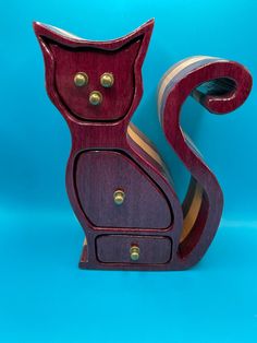 a wooden cat figurine on a blue background