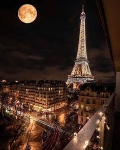 the eiffel tower is lit up at night