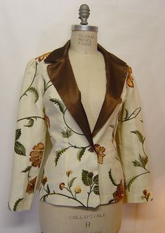 "Hand Made women's blazer with puffed sleeves, measurements are: Bust, 35; waist, 26; hip, 36; jacket length is 26\" long. Puff sleeve, 24\" long.  Hand made by the designer.  2 buttons in front, vintage bronze color metal buttons, one of a kind garment but I can make different sizes to order.  Lined inside without the sleeve. Dry clean only.  Outer fabric is linen cotton with machine embroidered flowers. Beautiful jacket. Lining is polysatin." Luxury Embroidered Long Sleeve Blazer, Luxury Floral Print Blazer For Workwear, Luxury Festive Blazer With Floral Embroidery, Luxury Long Sleeve Embroidered Blazer, Luxury Floral Embroidered Blazer For Party, Luxury Wedding Blazer With Intricate Embroidery, Luxury Embroidered Ceremonial Blazer, Luxury Women's Blazer With Floral Embroidery, Luxury Floral Embroidery Women's Blazer