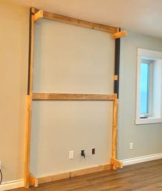 an empty room with no furniture in it and wood flooring is being installed on the walls