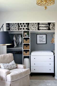 a baby's nursery closet with white furniture and black and white accessories on shelves