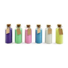 five bottles with different colored sand in them and one has a tag on the top