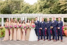 a group of people standing next to each other in front of a white pergola