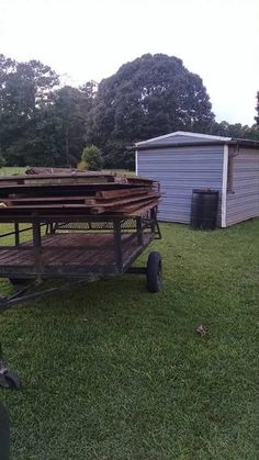 an old wagon is sitting in the grass