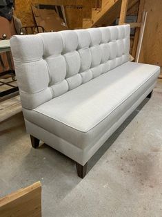 a white couch sitting on top of a wooden floor