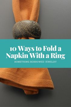 an orange scarf hanging on a hook with the words 10 ways to fold a napkin with a ring