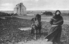 an old photo of a woman standing next to a horse