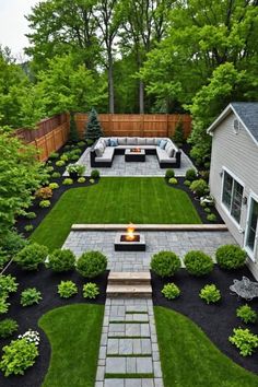 an outdoor patio and fire pit surrounded by grass