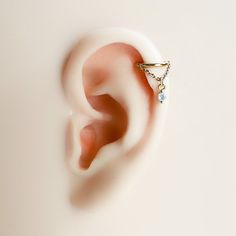 a pair of ear piercings sitting on top of a white surface