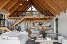 a living room filled with furniture and a wooden ceiling