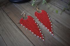 These gorgeous long red beaded earrings are made with high quality Japanese, Czech glass seed beads and Gold tone ear wire hooks. Other finishes are also available.  5" inches in length 1 1/4 " wide *All orders are shipped within 3-7 business days (after the order has been placed) by first class mail with a tracking information. If you need sooner please let me know. All custom orders will be shipped within 1-2 weeks. *All pieces are handmade and each piece is unique and should be handled with c Red Faceted Beads Earrings For Festive Occasions, Elegant Red Beaded Earrings For Festival, Handmade Red Beaded Long Drop Earrings, Handmade Red Long Drop Beaded Earrings, Red Round Bead Earrings For Festivals, Red Long Drop Beaded Earrings, Red Long Drop Beaded Earrings In Bohemian Style, Red Long Drop Beaded Bohemian Earrings, Red Bohemian Long Drop Beaded Earrings