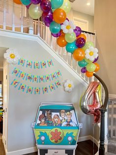 a birthday decoration with balloons and an ice cream truck in front of the cake table