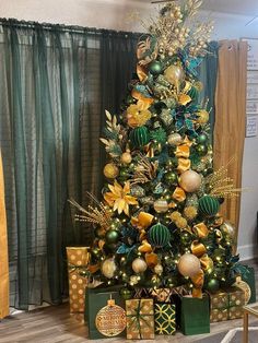 a christmas tree decorated with gold and green ornaments