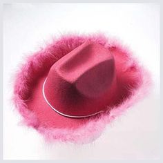 a red hat with pink fur around it on a white surface, in the shape of a circle