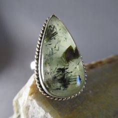 Smooth, Soothing Moss Agate Teardrop Ring, Set In Sterling Silver And Striking On The Hand! Moss Agate Is Said To Encourage Tranquility And Emotional Balance. This Elongated Drop Of Natural Design Embodies Balance, With The Graceful Length Of The Cut Creating Elegance From Such A Large Stone. The Dark Green Inclusions Are Bold, Like An Abstract Painting Of Mountains And Lake. This Ring Is Currently Size 9. The Moss Agate Teardrop Design Measures 30 Mm From Top To Bottom. That Translates To Just Belly Button Piercing Rings, Mountains And Lake, Amethyst Cocktail Ring, Moss Agate Jewelry, Rose Gold Ring Set, Yellow Gold Solitaire Ring, Silver Flower Ring, Estate Rings, Teardrop Ring