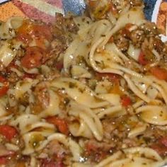 a bowl filled with pasta and meat on top of a table