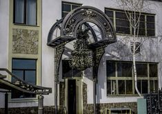 an old building with a clock on the front and side of it's door