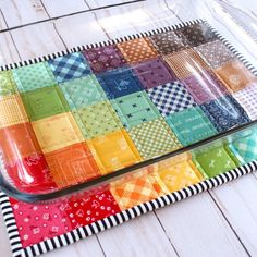 a colorful patchwork tray on a white wooden floor