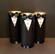 three black canisters with white and silver bow ties