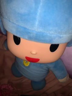 a close up of a stuffed animal wearing a blue hat