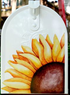 a close up of a mailbox with a painting of a sunflower on it