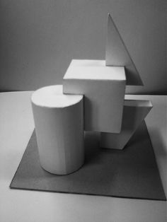 a black and white photo of an abstract sculpture on a mat with one piece cut out