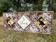 a sign with two pictures on it in the grass and trees behind it that says the family