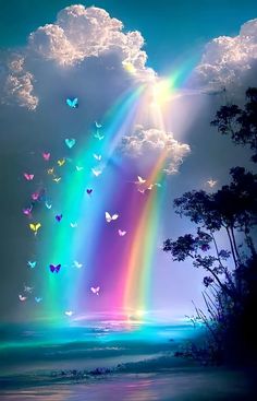 a rainbow in the sky with many butterflies flying over it and some trees on the beach