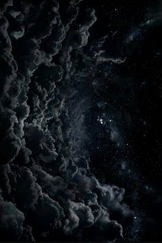 the night sky is filled with clouds and stars