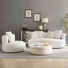 a living room filled with white furniture and decor