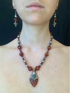 Antique Native American silver beads, with carnelian and turquoise. Elaborate pendant with the same materials.  Matching earrings. Bohemian Amber Jewelry With Silver Beads, Silver Carnelian Beaded Jewelry, Bohemian Silver Beaded Necklaces With Carnelian, Bohemian Teardrop Carnelian Jewelry, Pretty Jewelry, Necklace And Earring Set, Turquoise Pendant, Pretty Jewellery, Matching Earrings