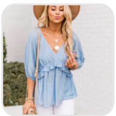 This Romantic Blue Blouse Is Such An Amazing Choice For Any Occasion! We Love The Cut Of The Babydoll Style And The Classic Blue Color. This Blouse Also Features A V-Neck And A Ruffle Along The Bust Line. Never Worn. Cute V-neck Blouse For The Beach, Cute V-neck Blouse For Beach, Cute Light Blue V-neck Top, Blue Ruffle Hem Top For Beach, Blue Ruffled Beach Blouse, Blue Ruffled Blouse For Beach, Summer Blouse With Ruffles In Light Wash, Light Blue Feminine Blouse For Summer, Light Wash Ruffled Blouse For Summer