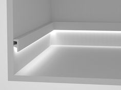 an empty white room with lights on the walls