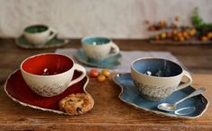 two cups and saucers on a wooden table