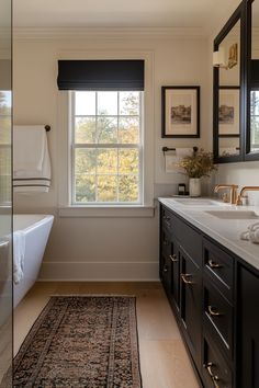 a bath room with a tub a sink and a mirror on the wall next to a window