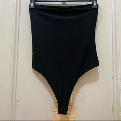 90% Nylon 10% Spandex Black Summer Bodysuit For Club, Seamless Stretch Bodysuit For Club, Summer Club Black Bodysuit, Black Summer Club Bodysuit, Black Elastane Bottoms For Club, Black Bodycon Bottoms For Summer, Black Stretch Shapewear Bodysuit, Seamless Black Bodysuit With High Stretch, Black Elastane Bodysuit For Night Out