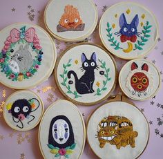 nine embroidered hoops with cartoon characters on them and stars in the sky behind them