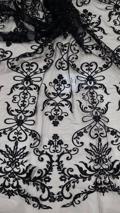 "Black color lace fabric. Sides are not scalloped. Width: 125 cm/49.2 inches Item number: EVS147C www.LaceToLove.com Price is set for one meter/yard. You will receive the fabric in one continuous piece if you purchase more than 1 meter/yard. Actual color may vary greatly form the color you see on screen. It depends on your devices screen brightness/settings. We recommend you to buy a sample before ordering to see the true color. You can purchase a sample here: https://www.etsy.com/listing/248526 Elegant Embroidered Lace Fabric, Elegant Embroidered Fabric With Lace Trim For Party, Embroidered Lace Fabric For Party, Party Lace Embroidered Fabric And Notions, Party Lace Fabric With Embroidery, Elegant Embroidered Lace Tulle Fabric, Elegant Embroidered Net Lace, Black Lace Embroidered Fabric For Wedding, Lace Fabric With Intricate Embroidery For Ceremony