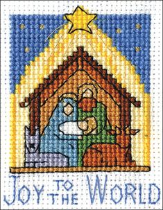 a cross stitch christmas card with an image of the birth of jesus and baby jesus