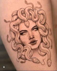 a woman's face with snakes on her thigh