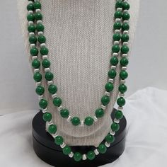 Introducing Our Stunning Two Strand Green Handmade Beaded Necklace, With An Inner Strand Of 21.5” And An Outer Strand Of 24.5”. It's Finished With A Silver Clasp And Silver Spacers - An Irresistible Combination! Important Features: Handmade 21.5" Inner Strand 24.5" Outer Strand Two Strand Green Beaded Necklace Silver Spacers Silver Clasp Silver Double Strand Beaded Necklace, Silver Long Necklace With Large Beads, Silver Double Strand Polished Bead Necklaces, Silver Beaded Necklace With Faceted Beads For Costume Jewelry, Silver Double Strand Necklace With Polished Beads, Silver Beaded Necklace With Faceted Beads, Silver Long Necklace With Single Strand Round Beads, Silver Long Necklace With Beaded Chain, Silver Long Necklace With Round Beaded Details