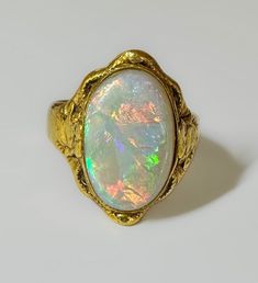 Antique Chinese late c1800s This is a gorgeous antique handcrafted ring with carved butterfly reliefs on both sides, featuring a 4.3 ct Australian Opal. The Opal almost looks semi black and it may be. It has an excellent color display with fire and quite a bit of flash.  The Band was replaced maybe 20 years ago with a thick 18k rose gold to blend with the high yellow 24k. The reasoning was that the 24k band kept getting bent and out of shape. In order to make it more wearable and sturdy, she had a 18k thick shank put on. It totally works and I would have never thought of doing that. Beautiful antique ring. 6.7g 24k solid yellow gold with 18k rose gold band Hallmarked old Chinese Australian Opal 4.3ct S 7 US resizable Very fine antique condition Heirloom Gold Opal Cabochon Ring, Heirloom Gold Opal Ring With Cabochon, Victorian Gold Opal Ring Gift, Victorian Gold Opal Ring For Wedding, Antique Gold Opal Ring For Anniversary, Antique Gold Opal Wedding Ring, Antique Gold Opal Ring For Wedding, Antique Gold Opal Ring For Formal Occasions, Classic Gold Opal Ring Collectible